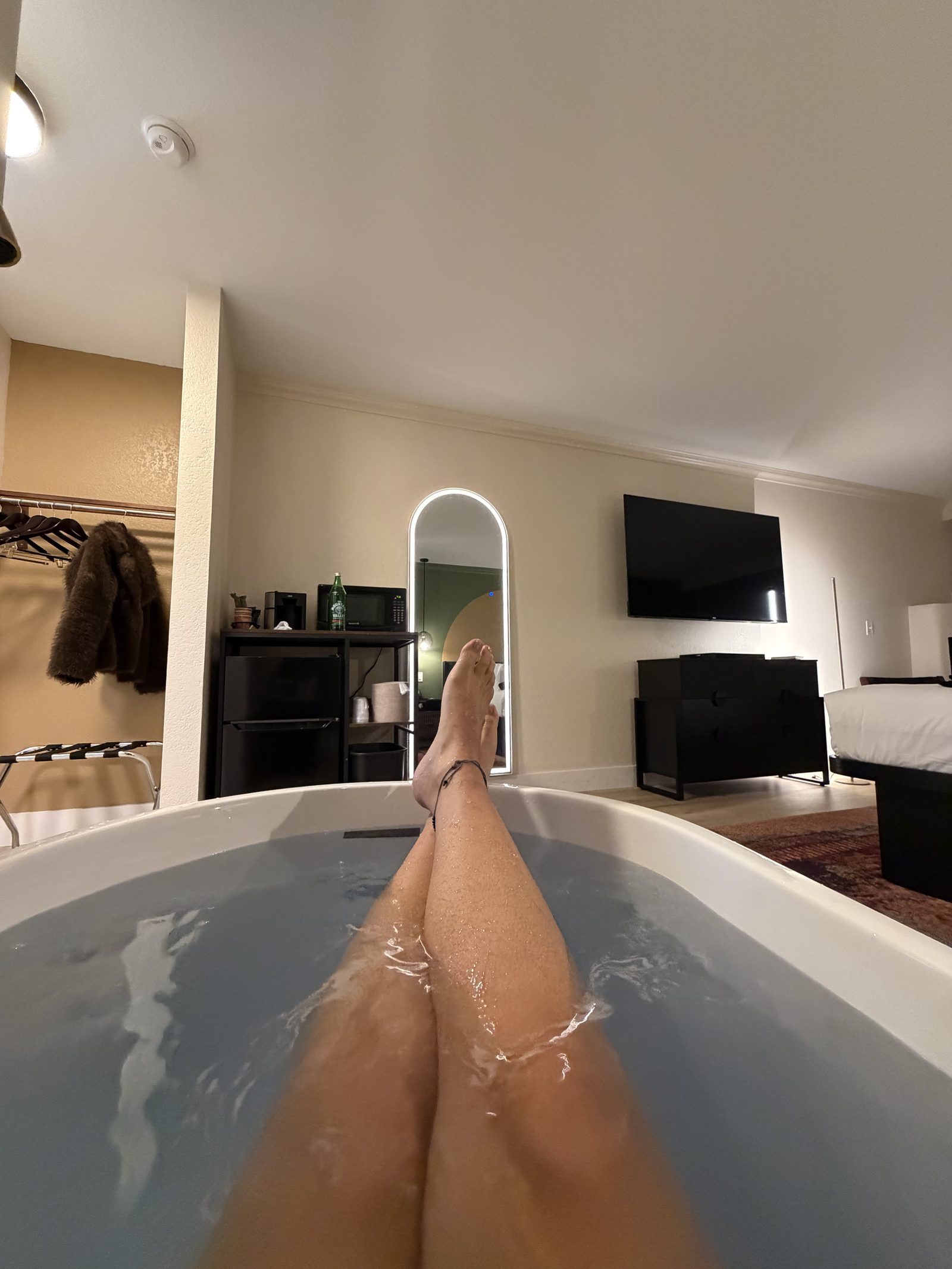 Guest relaxing in an in-room soaking tub